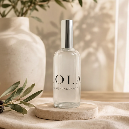 Lola Home Fragrance 100ml glass room spray bottle with silver cap on stone coaster